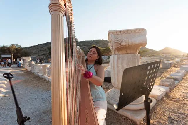 The harp at the end of the colonnaded ancient road, played in the evening light.