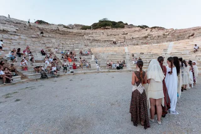 The audience spread across the theatre steps with the models on the orchestra floor.