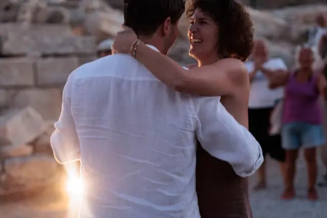A couple embracing in the sunset light at Knidos after the show.