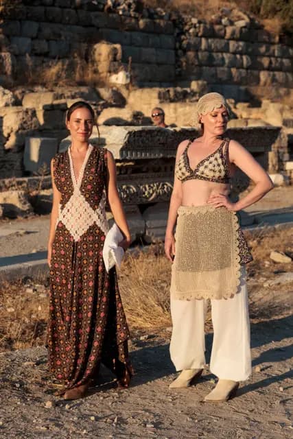 A long patterned dress and a lace-detailed look among the ancient stones.